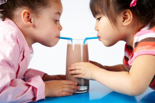 Girls Sharing Chocolate Milk